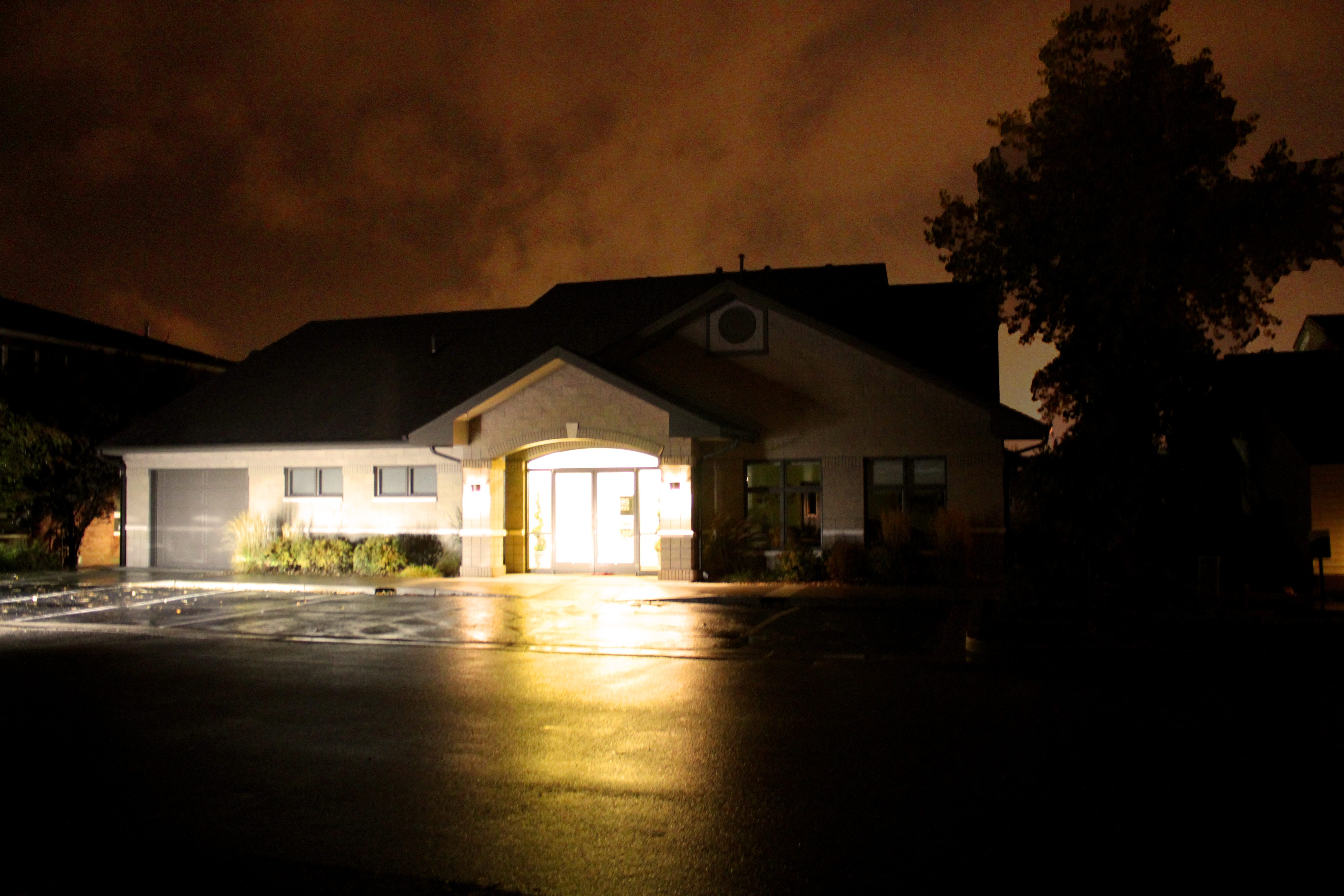 A house with lights on in the dark.